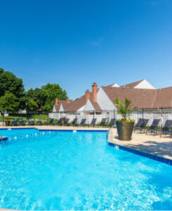 Bright blue saltwater swimming pool in front of pinegate west apartments